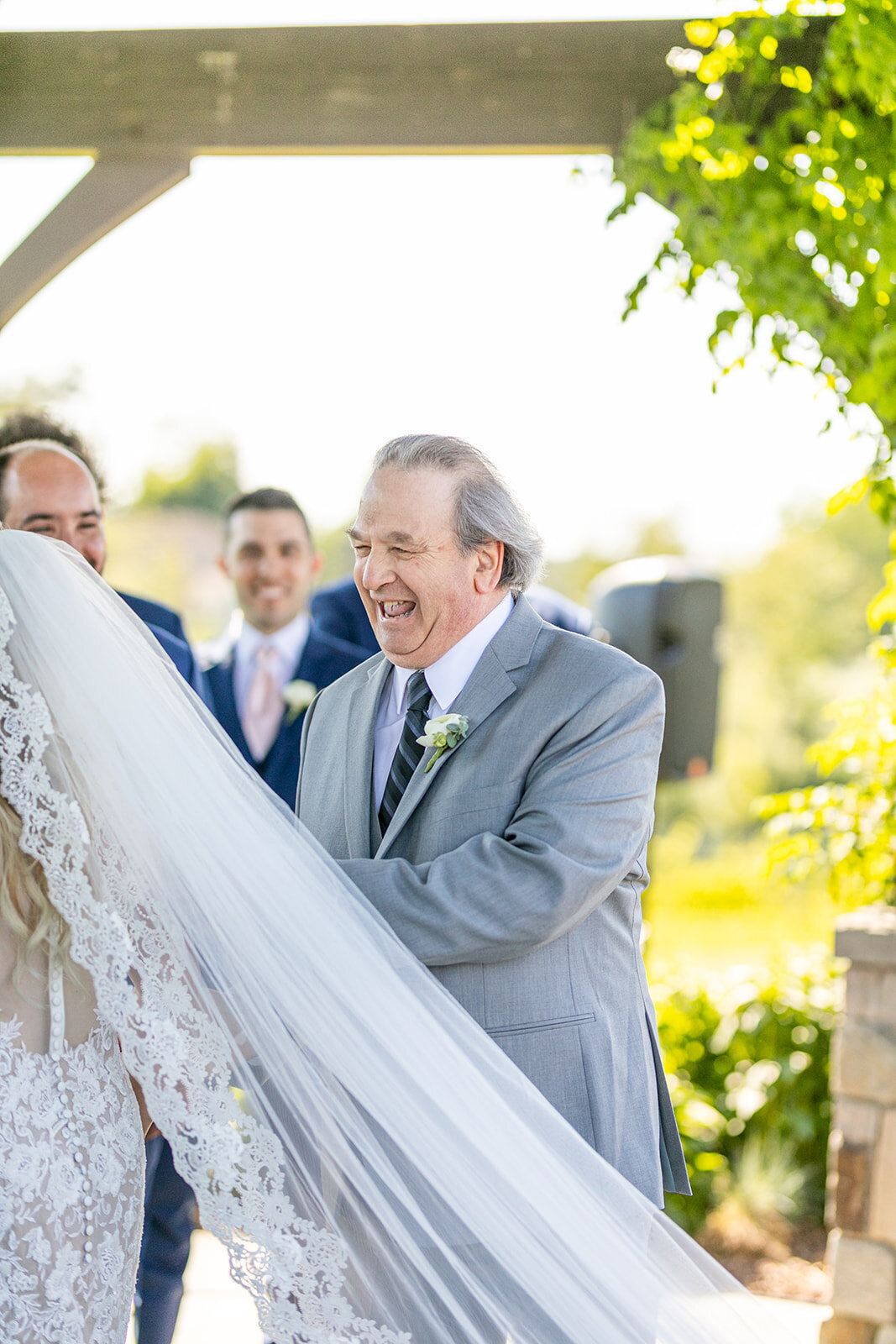 Uncle smiling as he walks bride down the aisle
