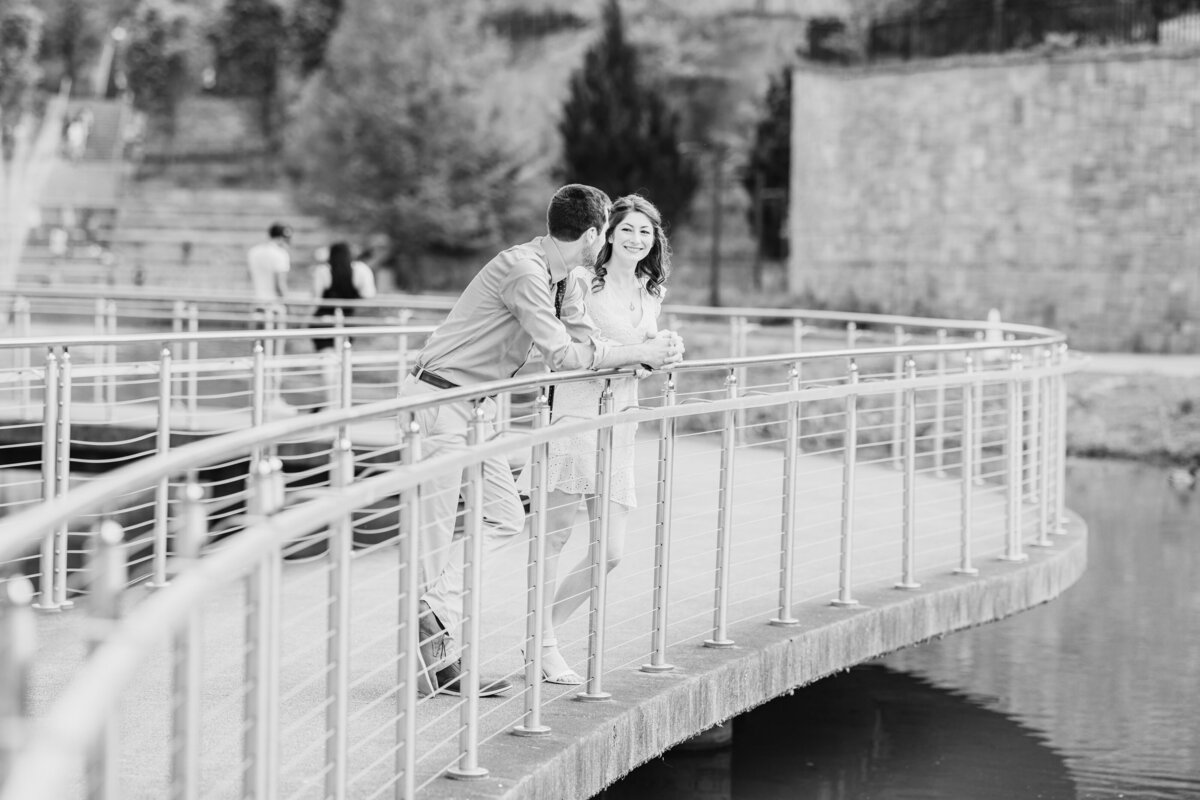 Bride and groom walking down the aisle, celebrating their new journey together in a joyful black-and-white moment, filled with laughter and cheers.