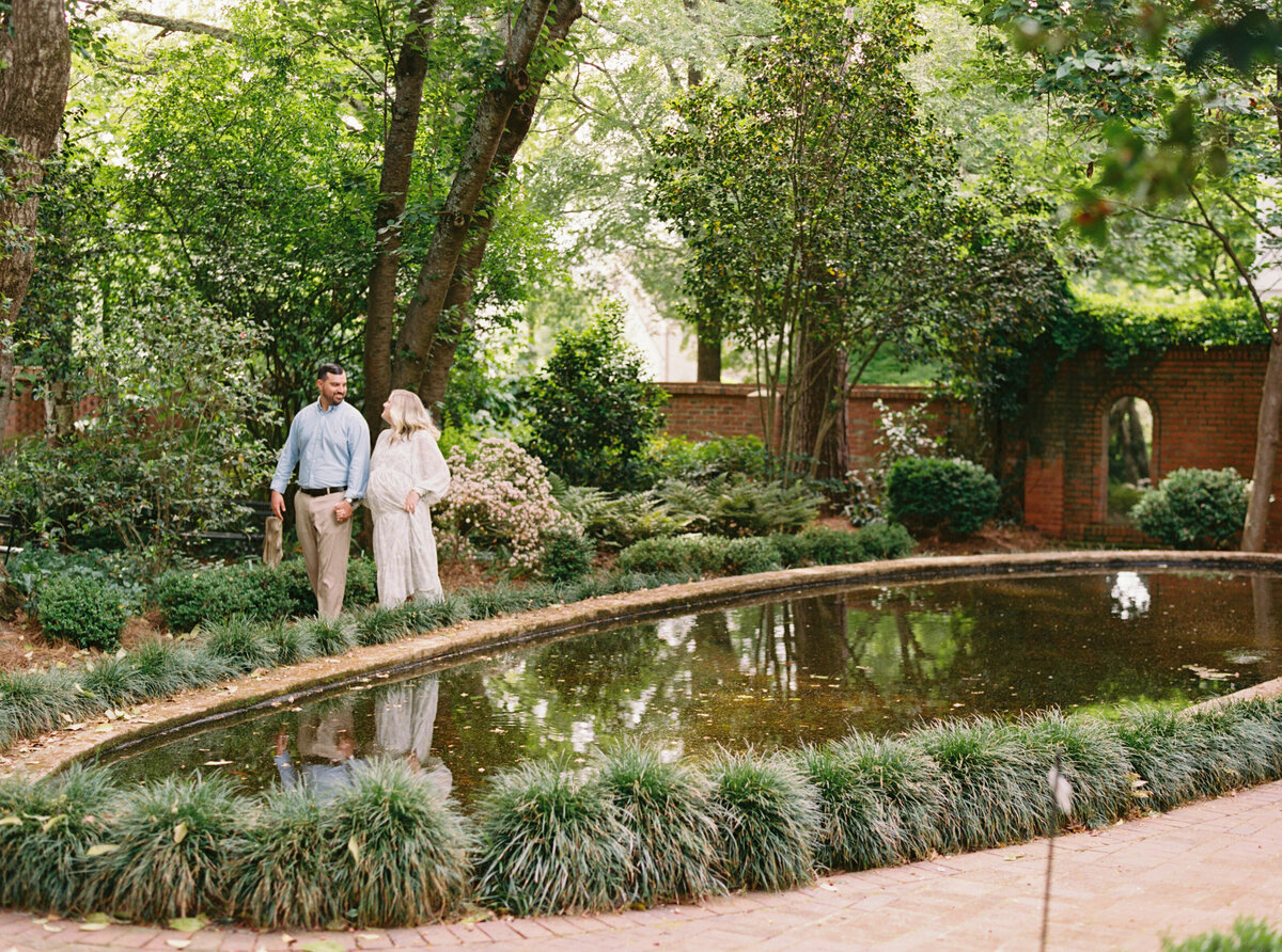 Couple walking through Wing Haven. Image by Raleigh maternity photographer A.J. Dunlap Photography.