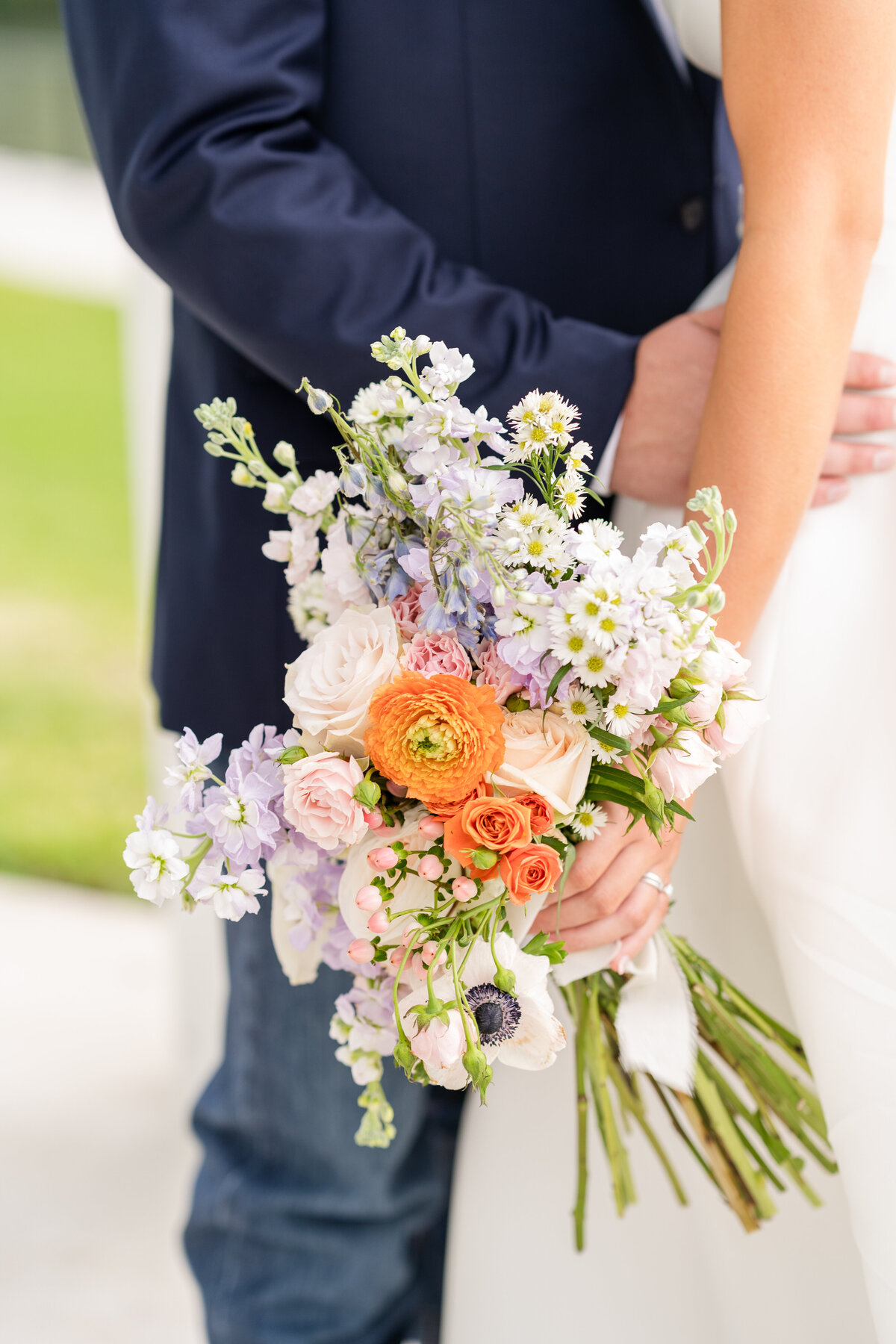 Colorful Bridal bouquet held by Bride at Zedler Mill venue