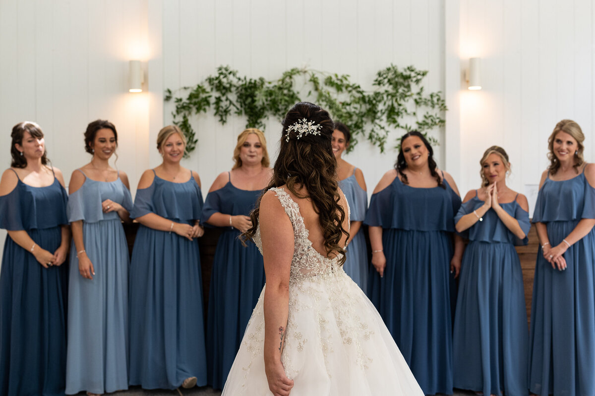 Bride twirls as she shows her friends her wedding dress