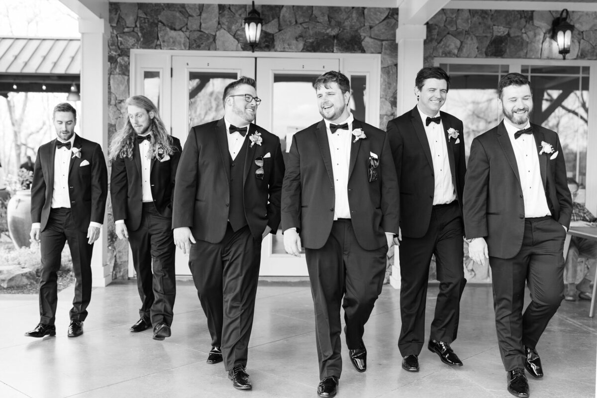 Groom and groomsmen walking and smiling