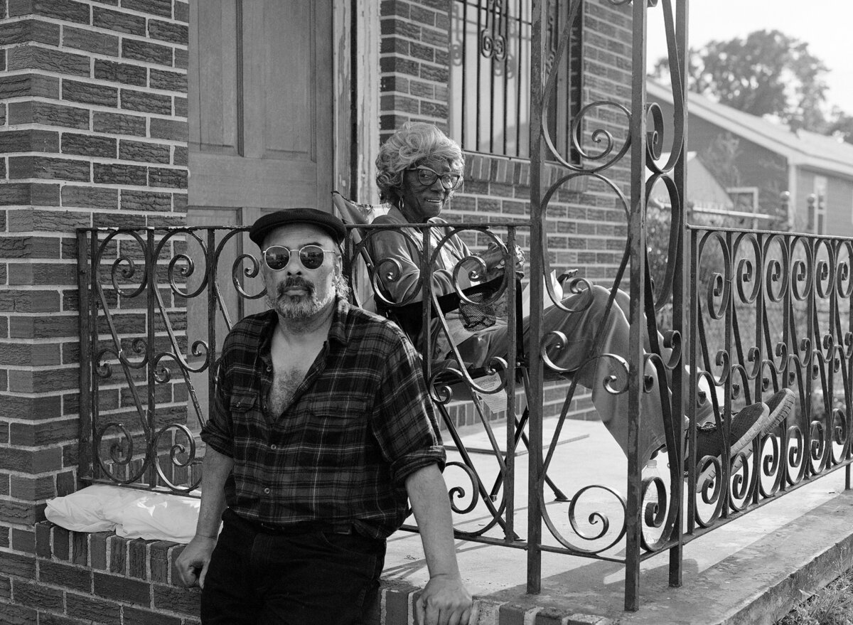 Elderly woman and man on porch mardi gras morning