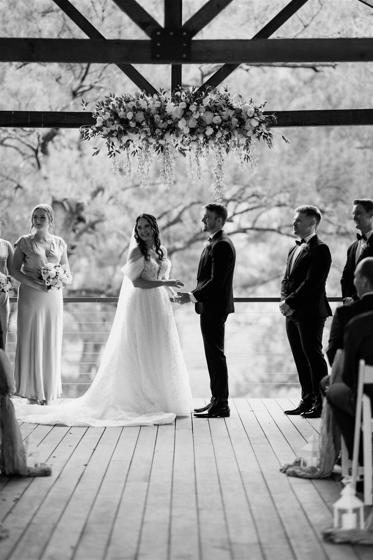 A couple stands lovingly together at the ceremony, radiating happiness and anticipation.