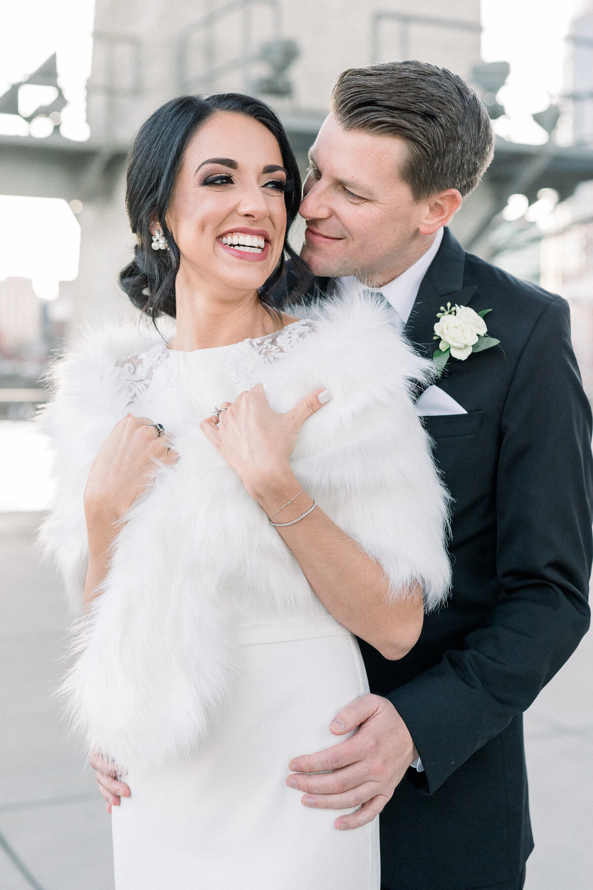 groom in tux and bride in fur downtown nashville wedding portraits