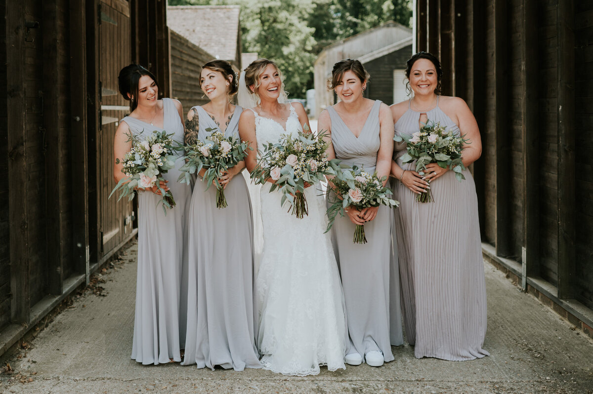 Bride and her bridesmaids laughing