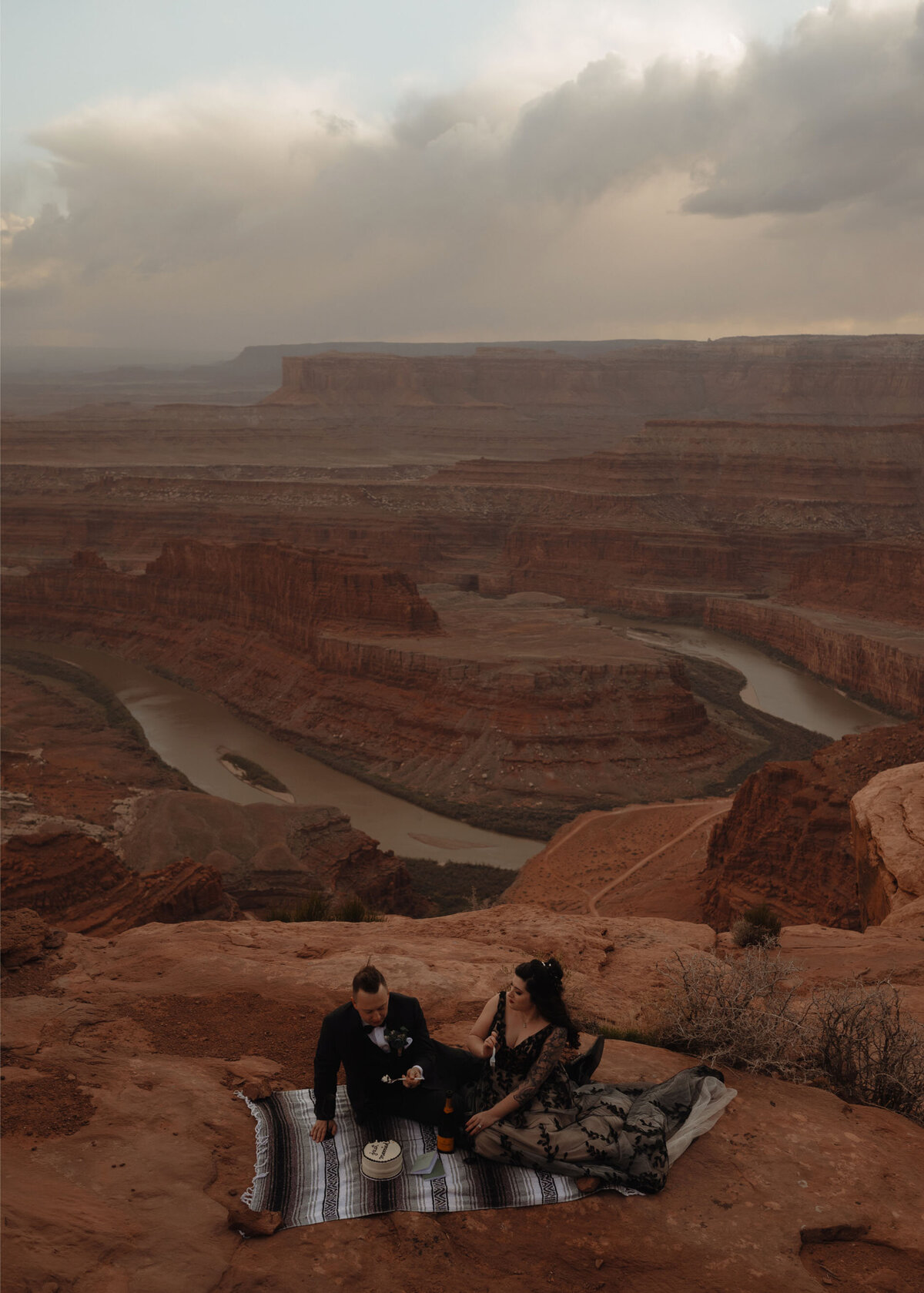 bride and groom celebrate their elopement by eating cake after their ceremony in Moab, UT