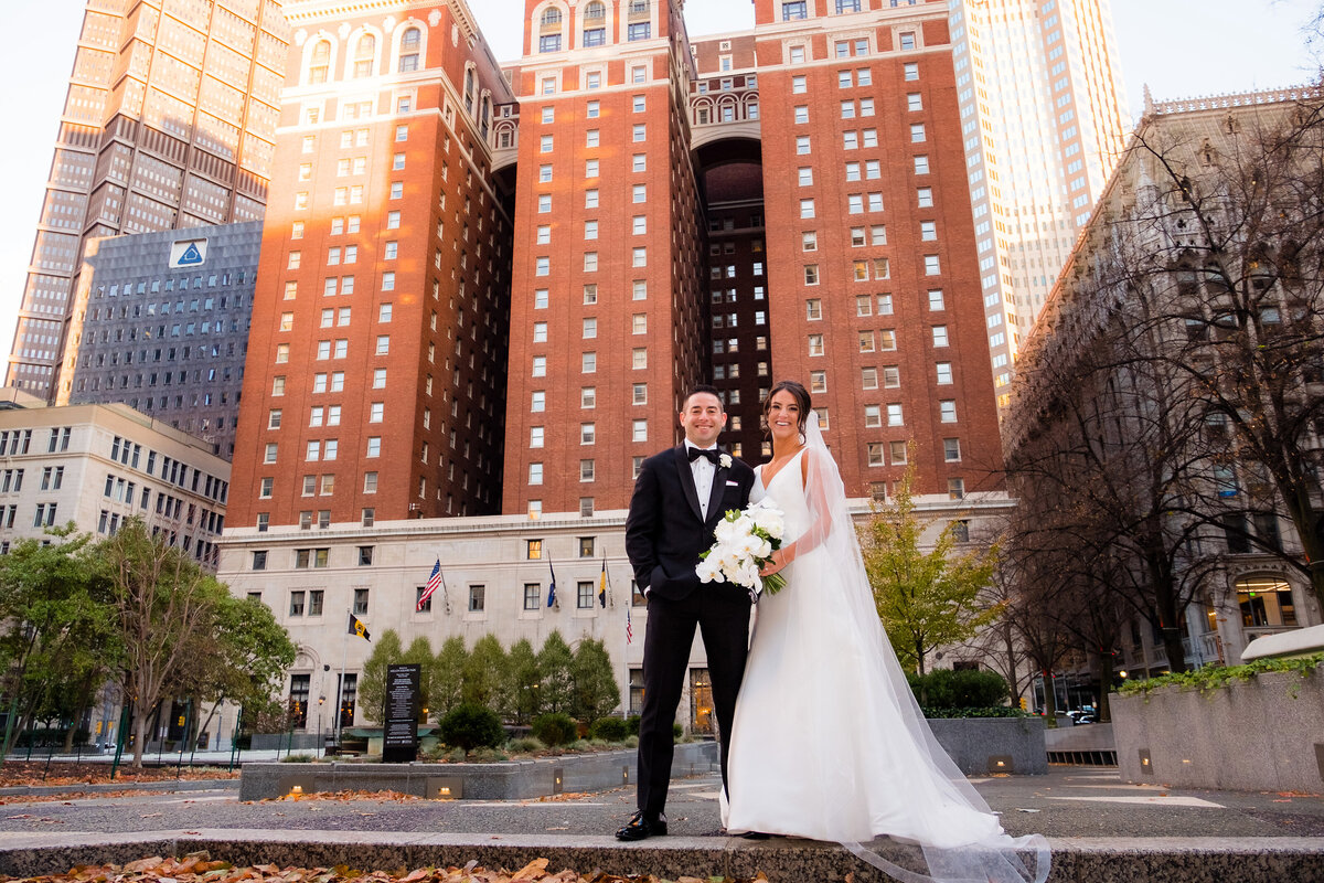 bride and groom smiling for photo in the mellon green at omni william penn