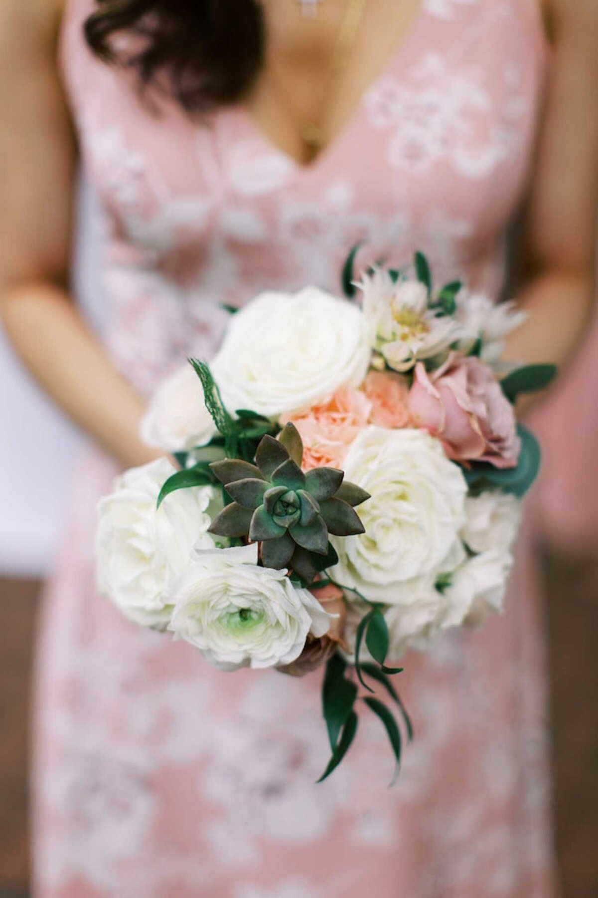 Garden succulent bohemian bouquet with a printed bridesmaid dress for a luxury Chicago outdoor garden wedding.