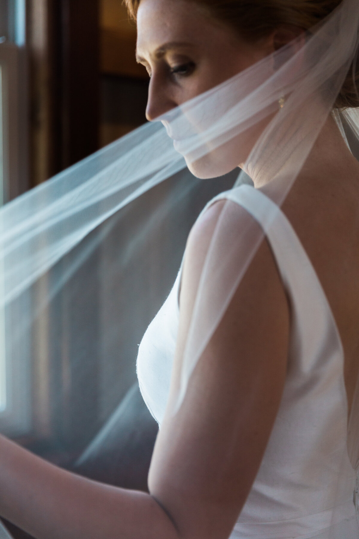 Close-up of bride holding her wedding veil