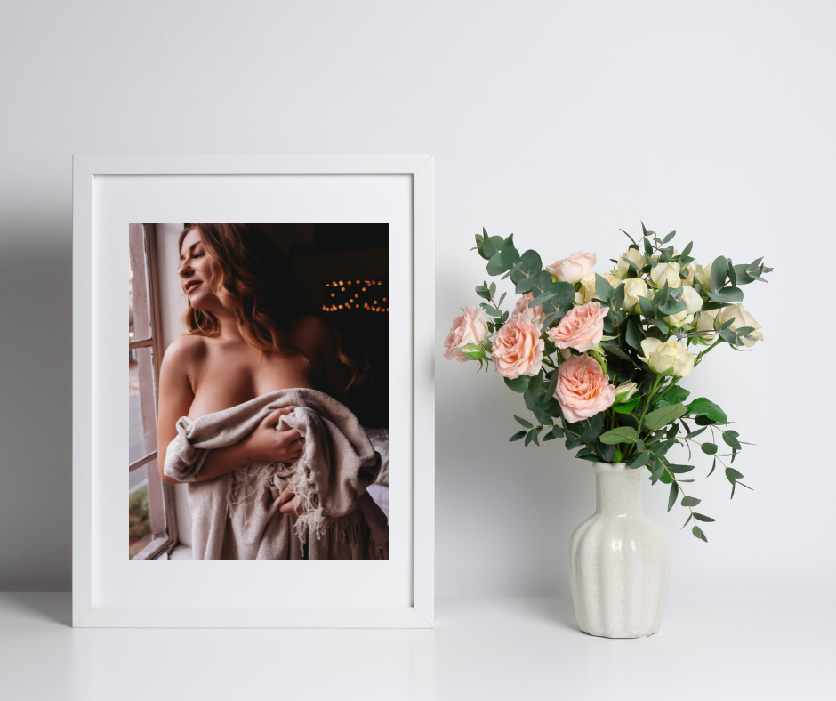 Boudoir standing art next to some peach roses  in a studio in Minneapolis Mn