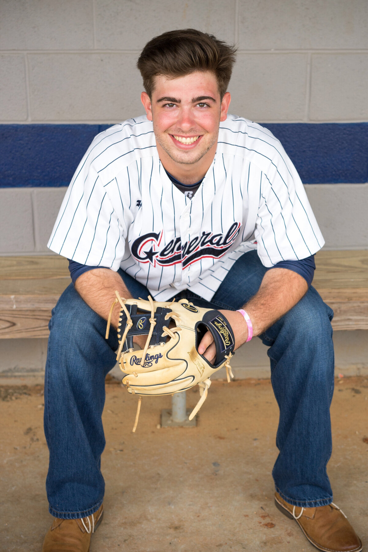 Kelley Hoagland is a north GA photographer taking senior portraits of teenager  in baseball uniform.