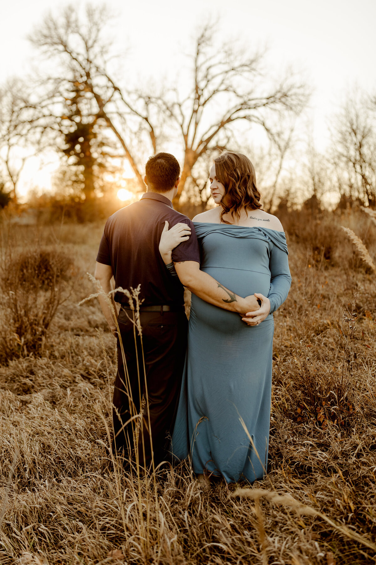 outdoor maternity session with mom and dad at pioneers park in Lincoln, Nebraska during the fall