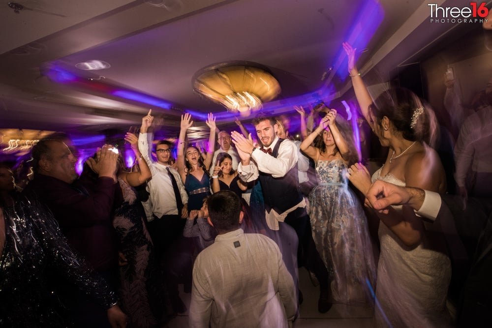 Guests party up on the dance floor during wedding reception