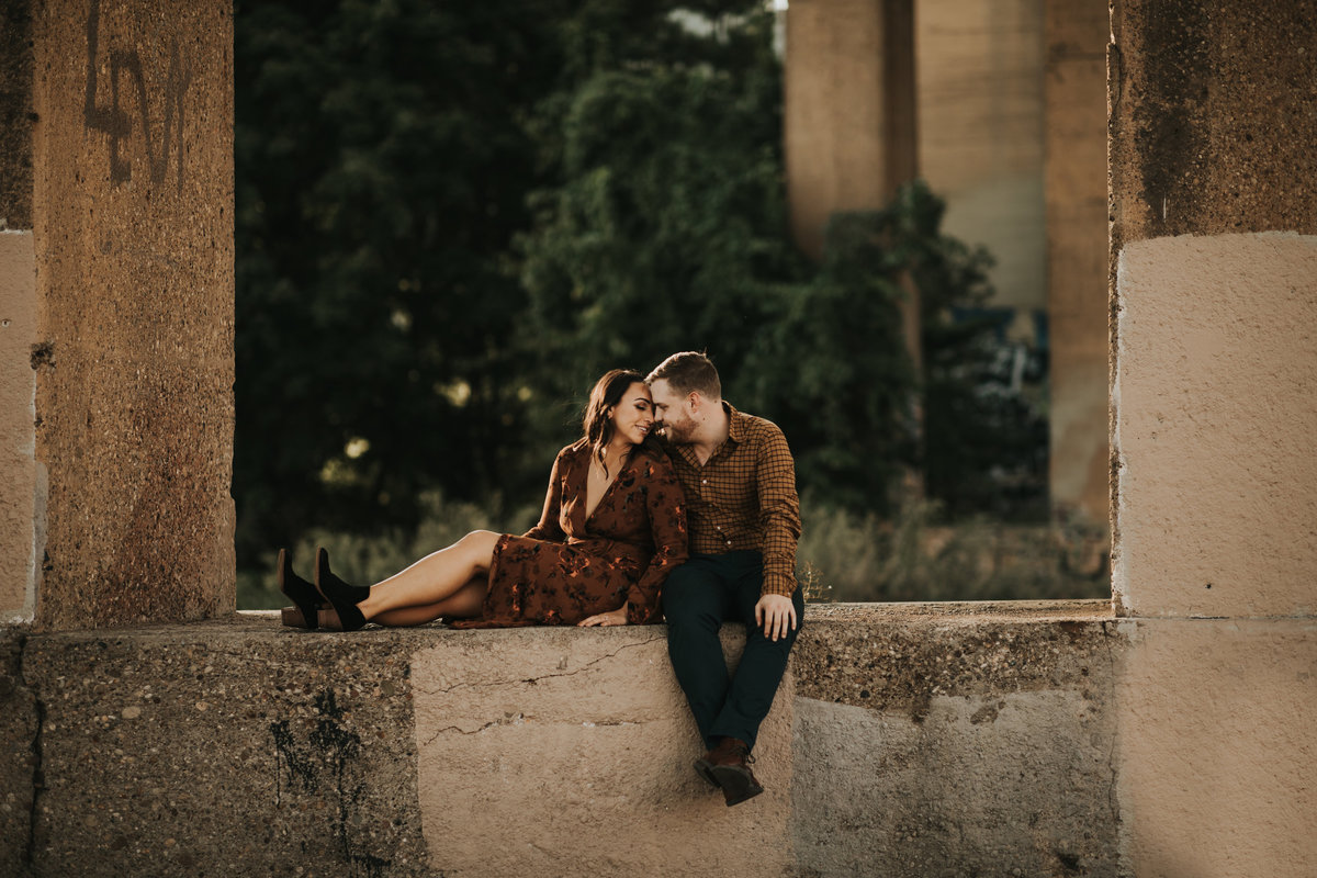 A couple under a Pittsburgh Bridge.