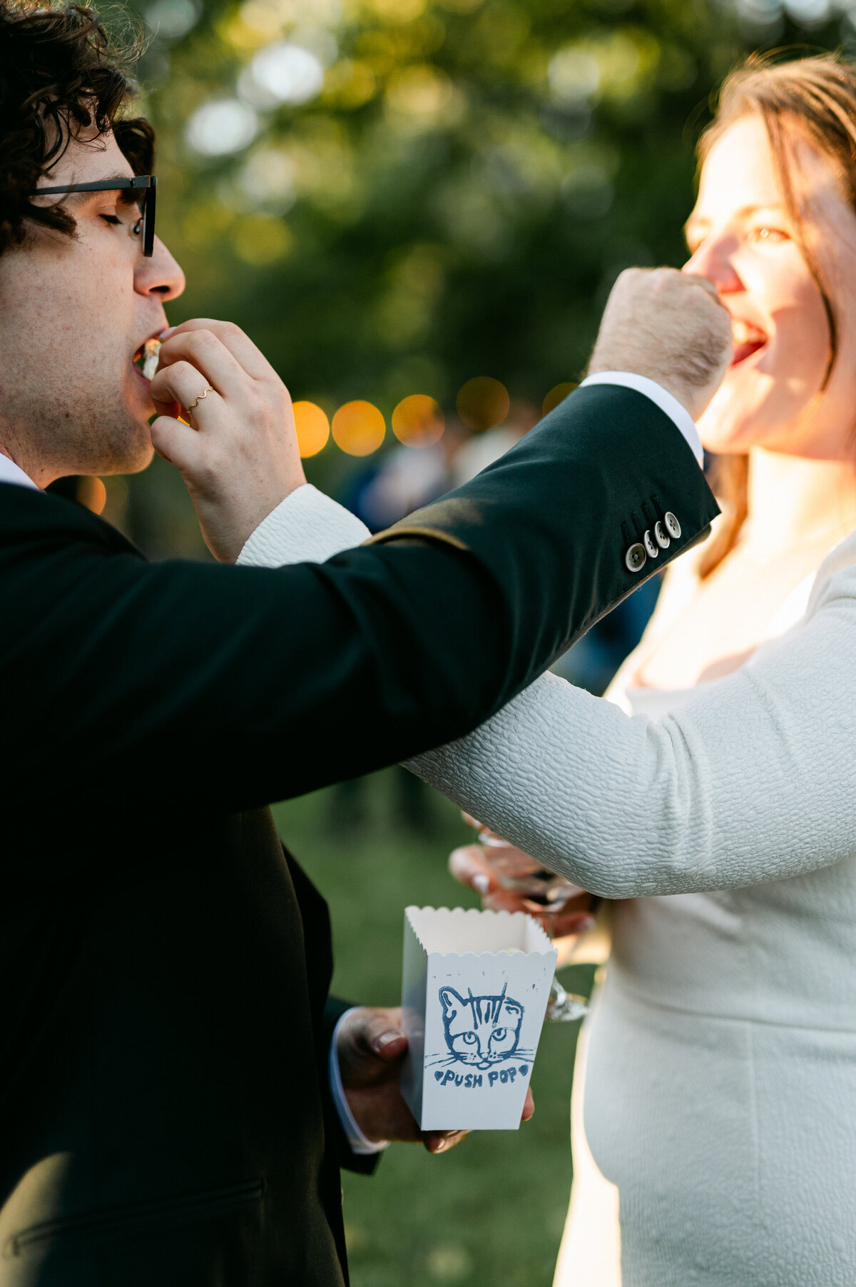 Bride and groom feeding each other popcorn