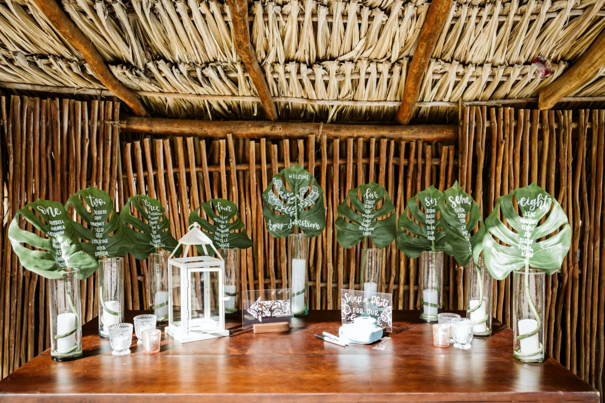 custom wedding signs on tropical leaves