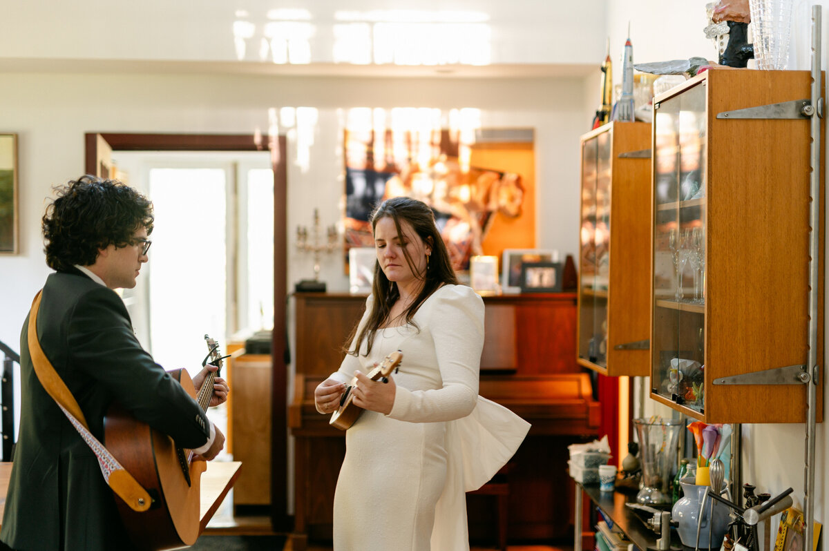 Bride and groom rehearsing with guitars before their wedding