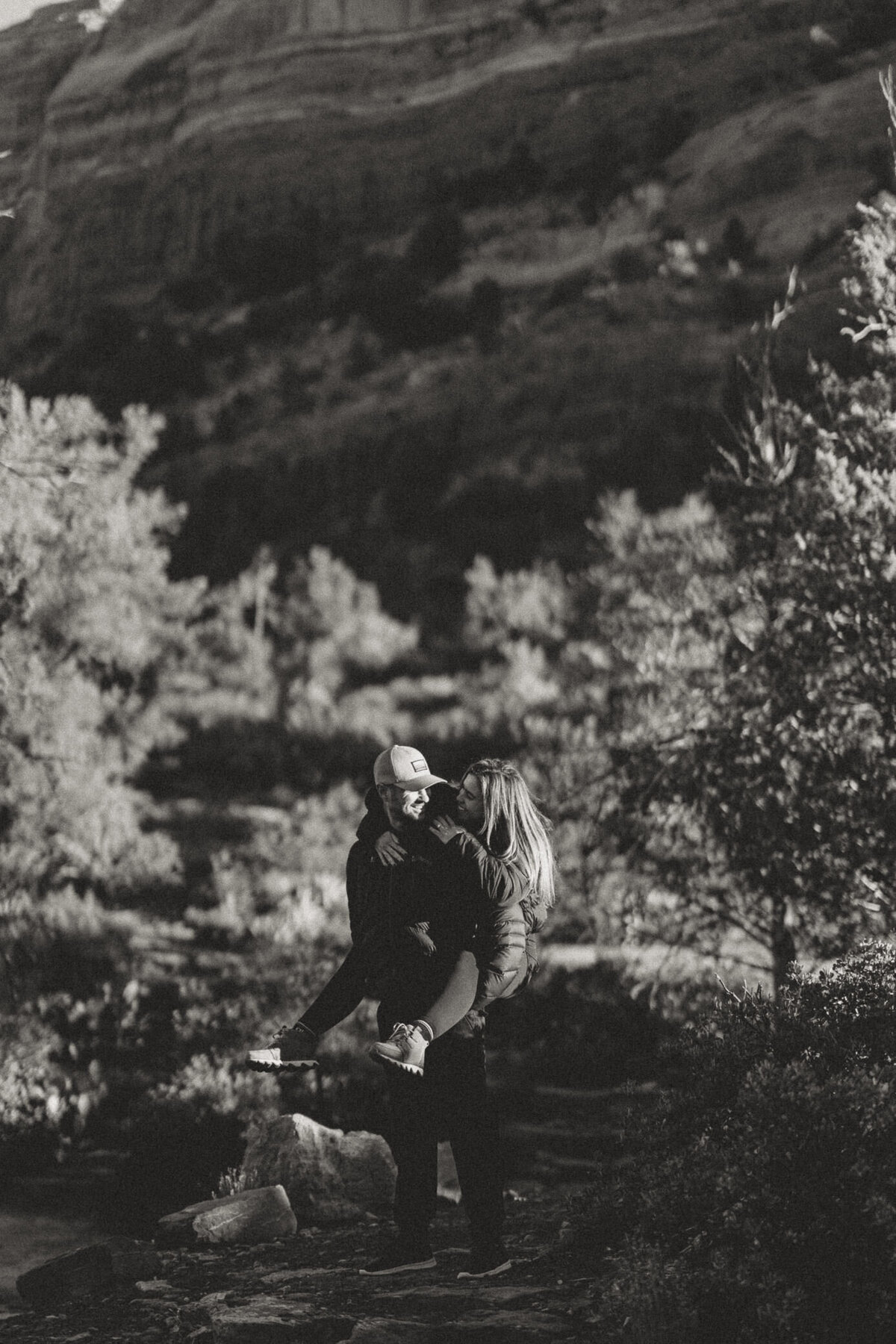 engaged-couple-piggyback-bw-sedona