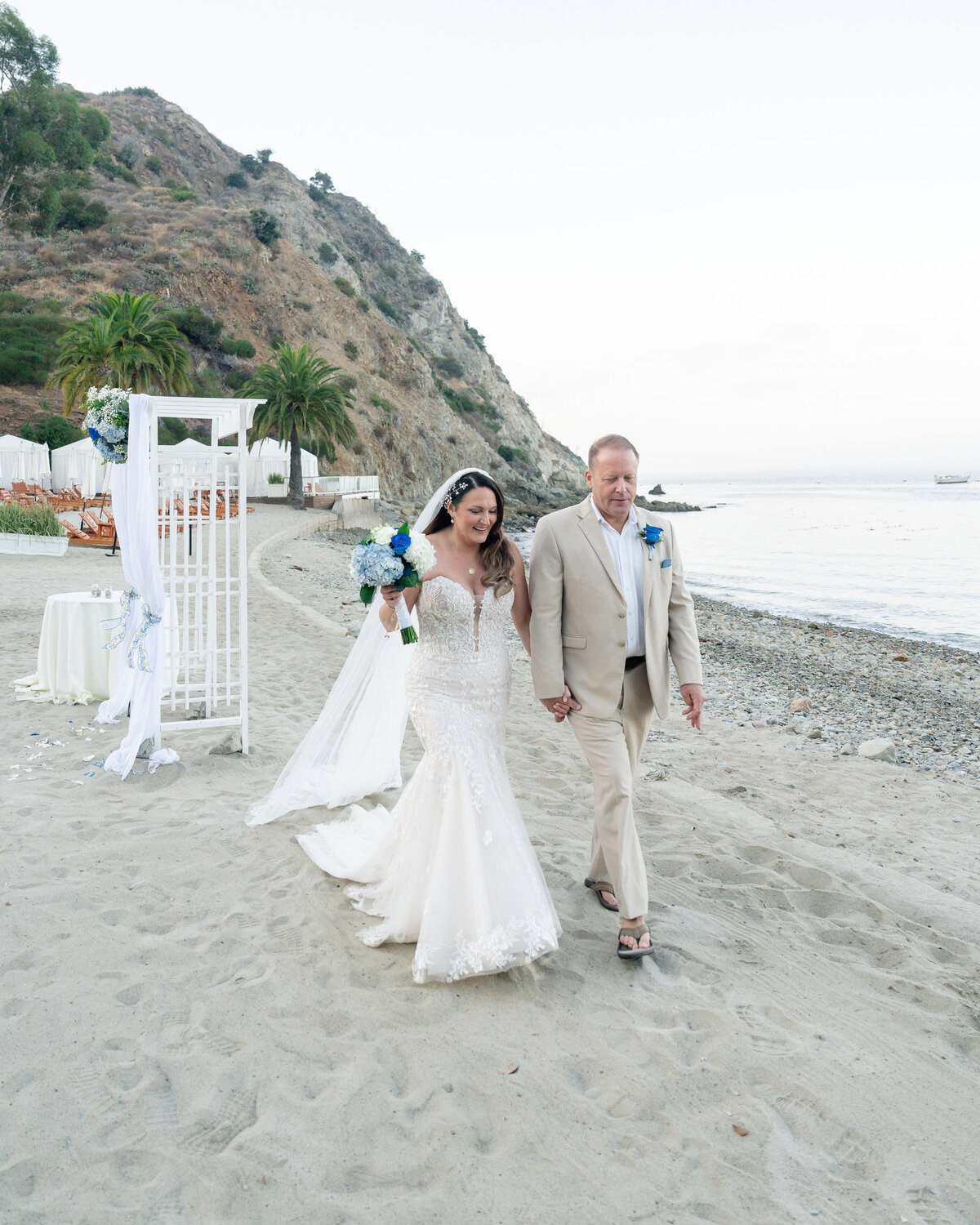 Bride and Groom eloping at Catalina Island venue Descanso Beach walking along beach during sunset.