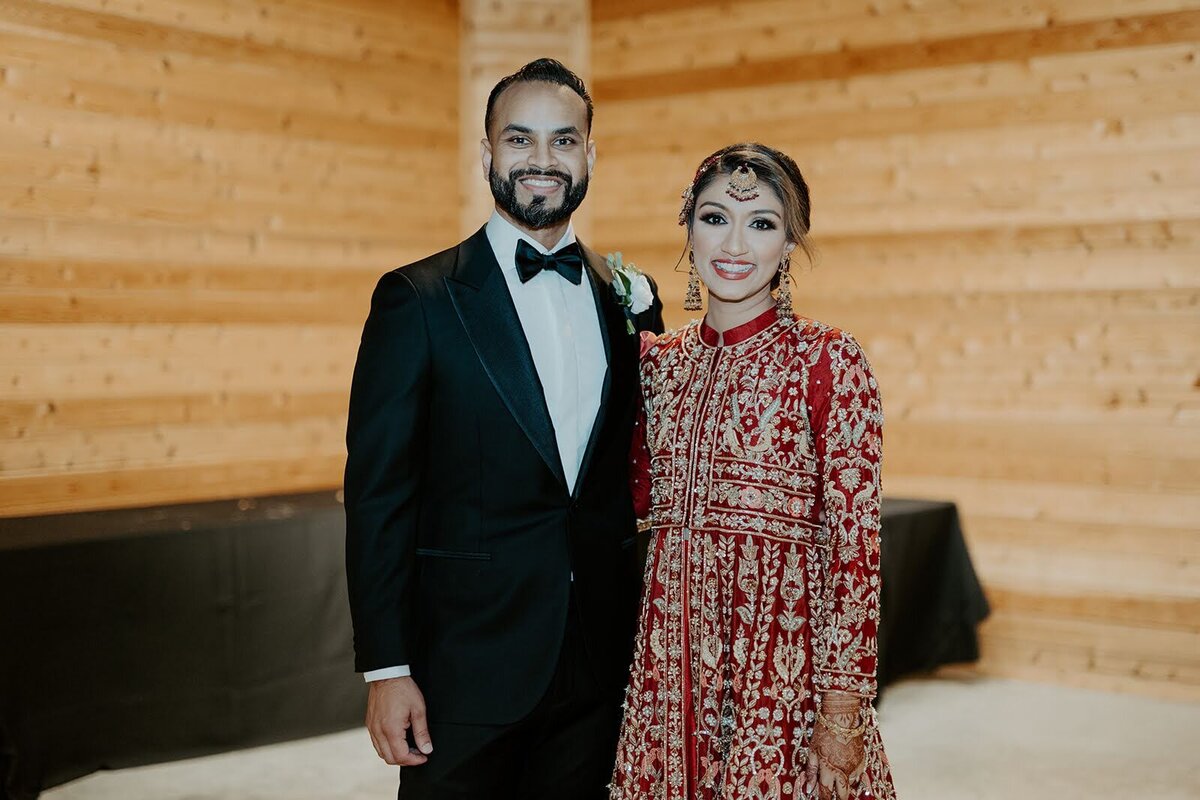 Bride and groom smile before hitting the dance floor at their wedding reception at the Bowery House and Gardens.