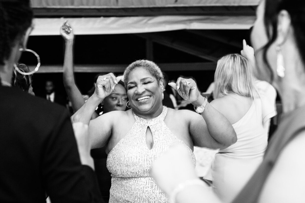 Joyous celebration with the bride dancing and guests cheering.