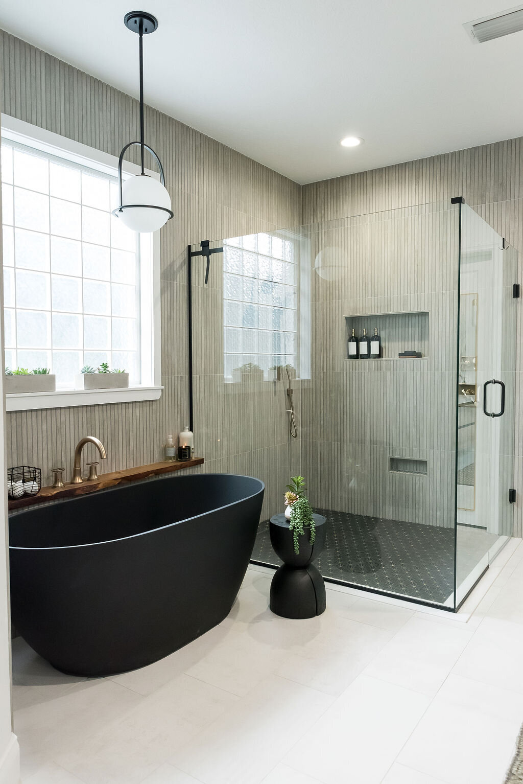 dewine design interiors hotel lux bathroom with black standing tub and large walk-in shower