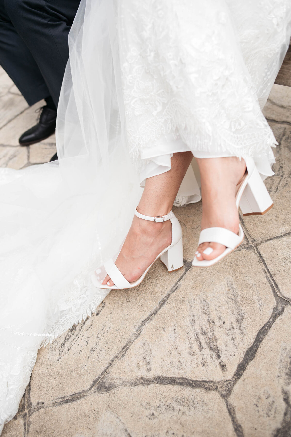 closeup of bride shoes on stone