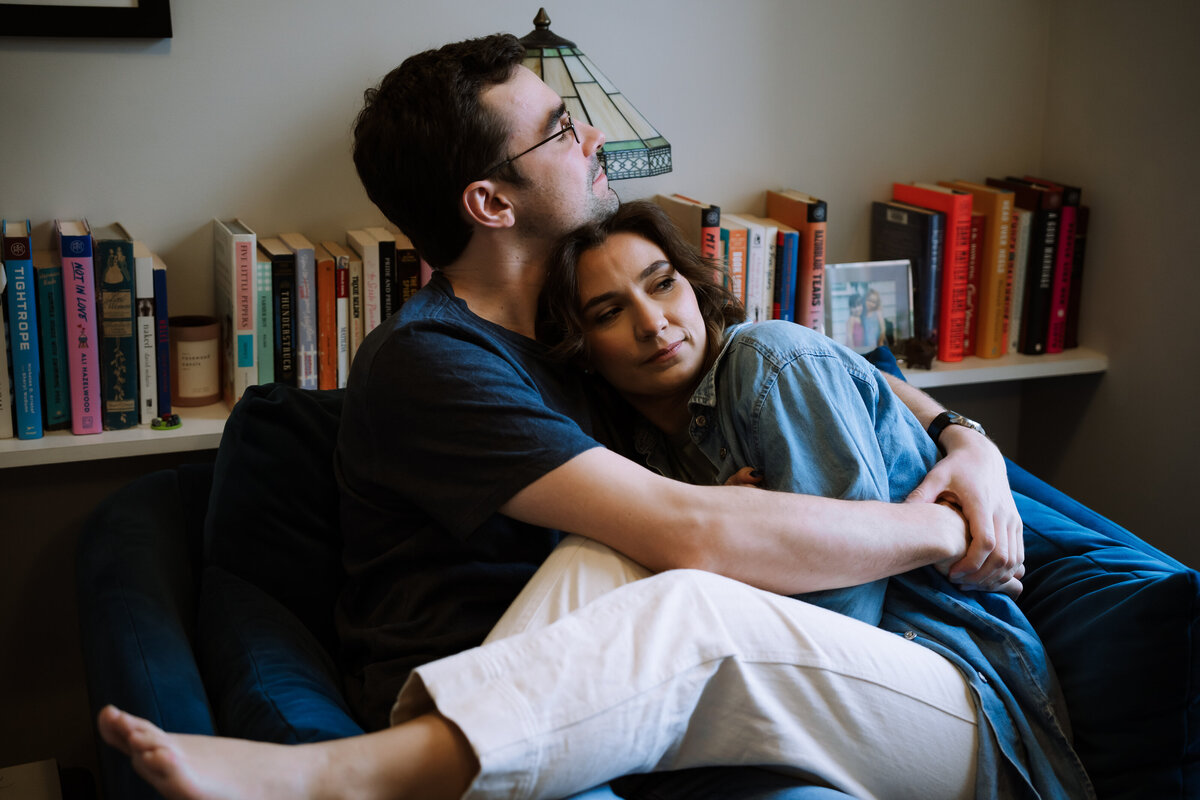 happy couple relaxing, sharing special moment in home office, home library