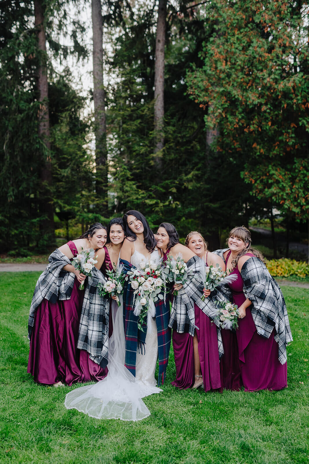 Bride with bridesmaids in maroon dresses and shawls