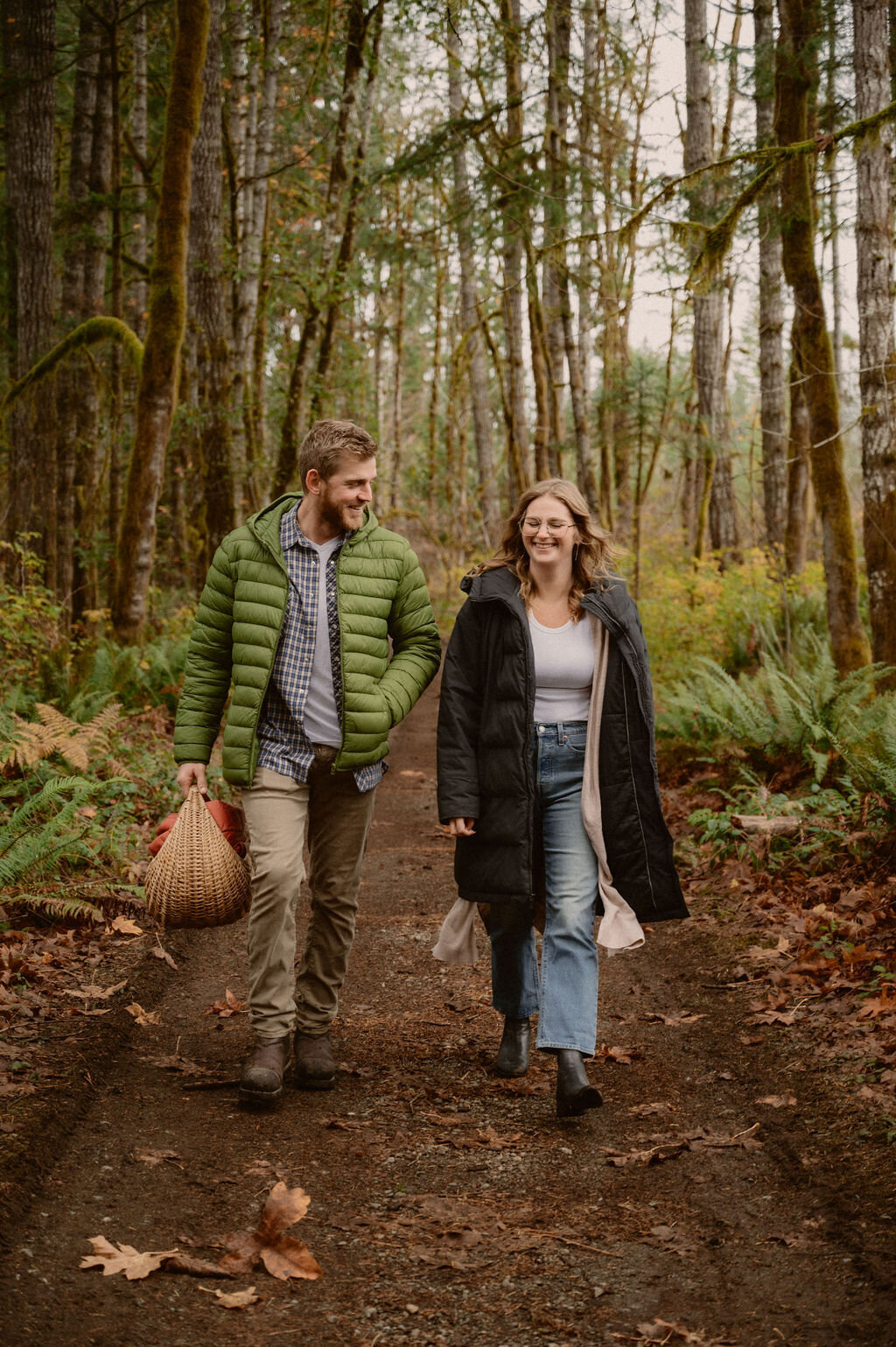 couple walking in nature trail  while smiling