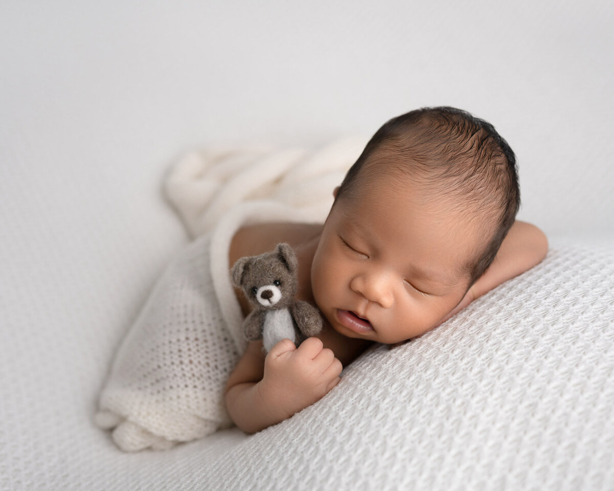 Newborn baby white wrap sleeping pose Leander professional photographer