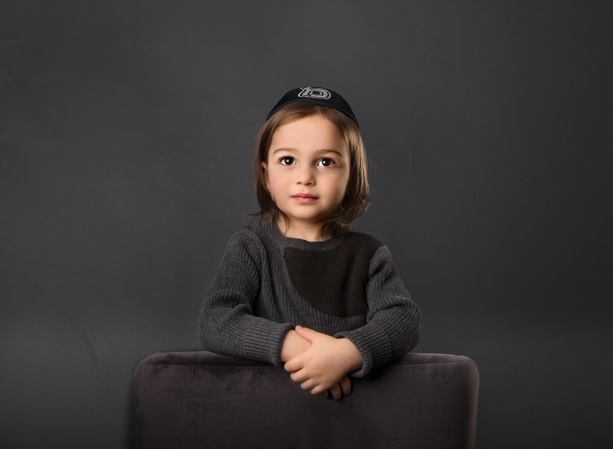 Little boy is captured in a kippah for a brooklyn ny photoshoot. Captured by brooklyn family photographer Chaya Bornstein.