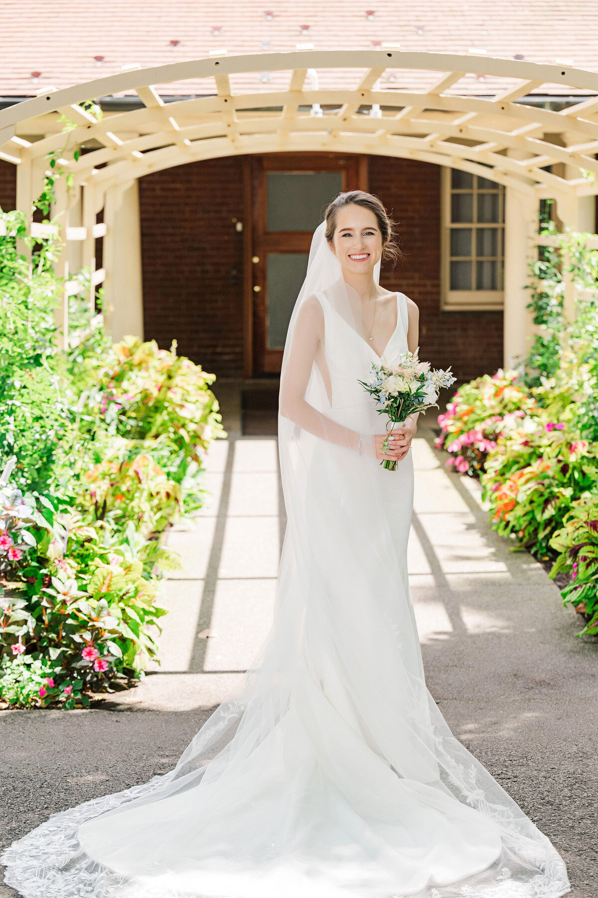 traditional bride on wedding day at the frick museum in wedding dress from bridal beginning