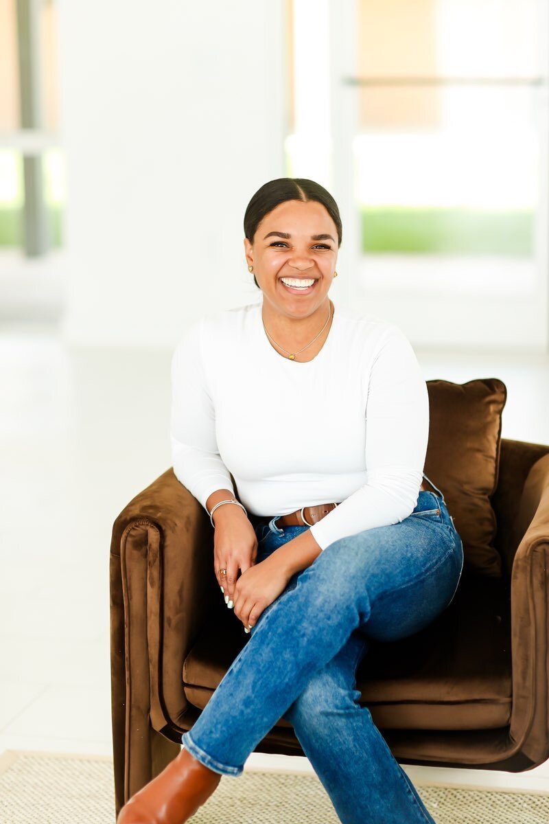model smiling in chair