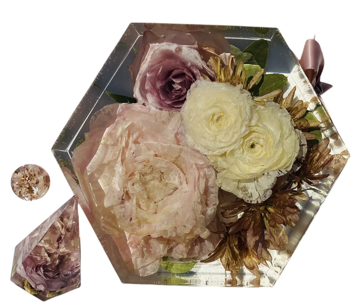 hexagon resin block with pink and cream wedding flowers preserved alongside grooms boutonniere as a timeless family keepsake