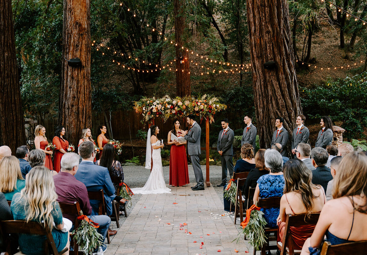 couple walking down outdoor stairs before archways