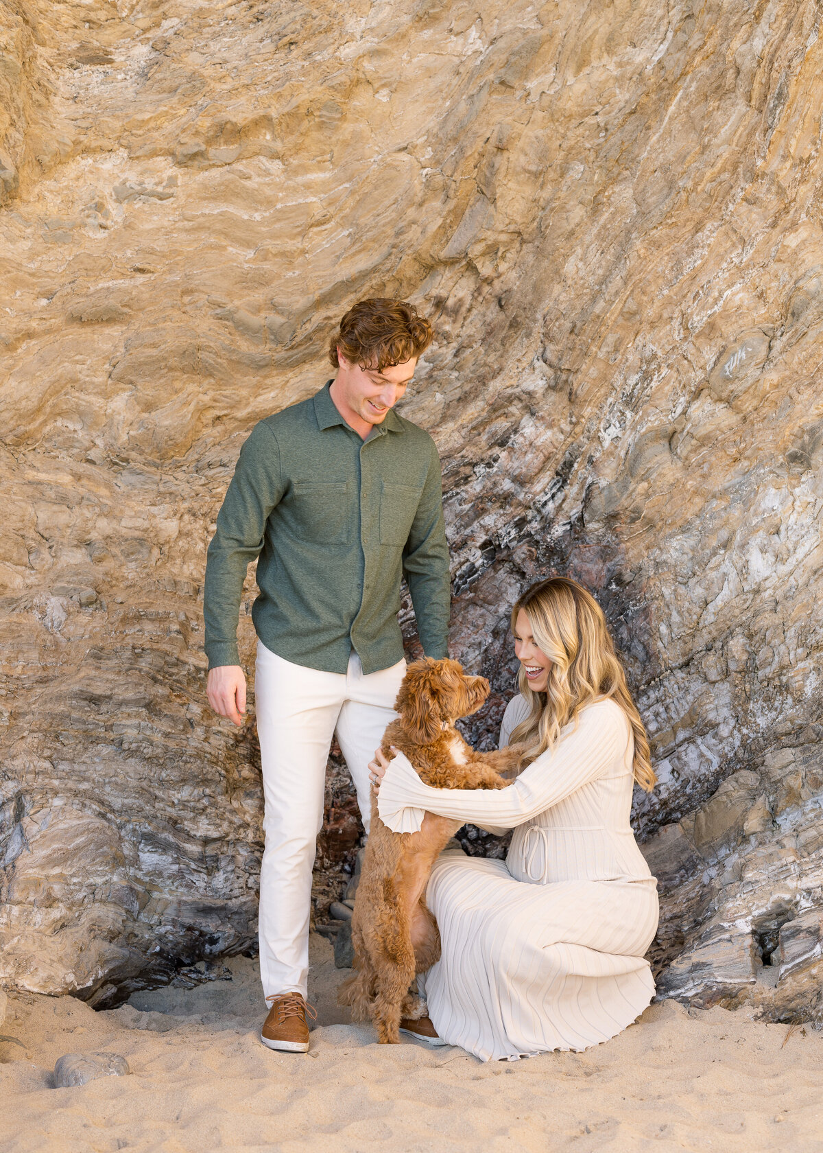 candid matenity photos on the beach with dog