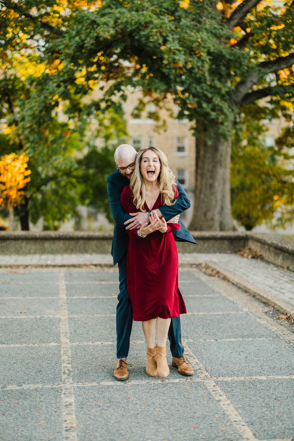 A newly engaged couple smiles at Meridian Hill.