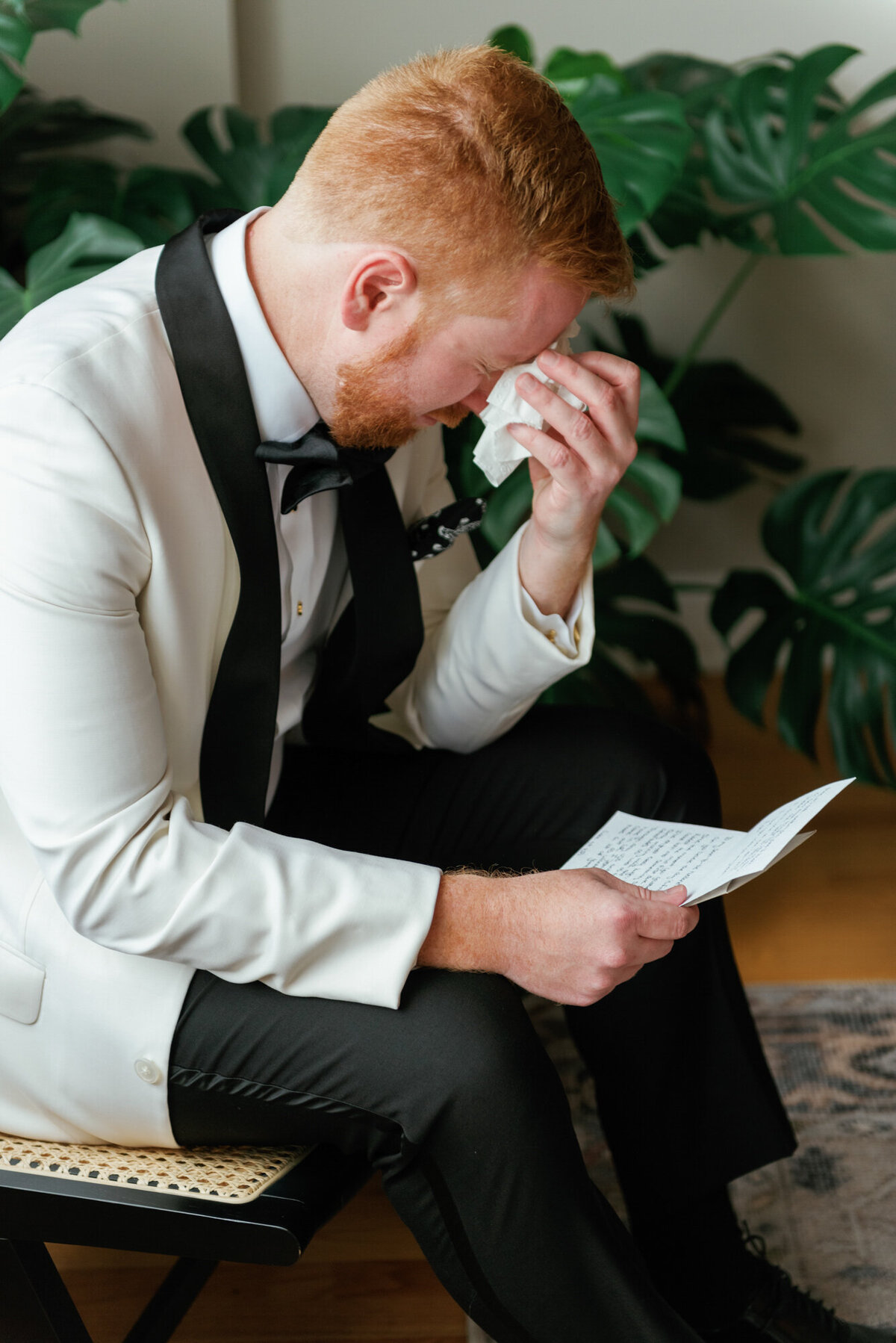 A groom cries as he reads a private note from his bride-to-be on their wedding day