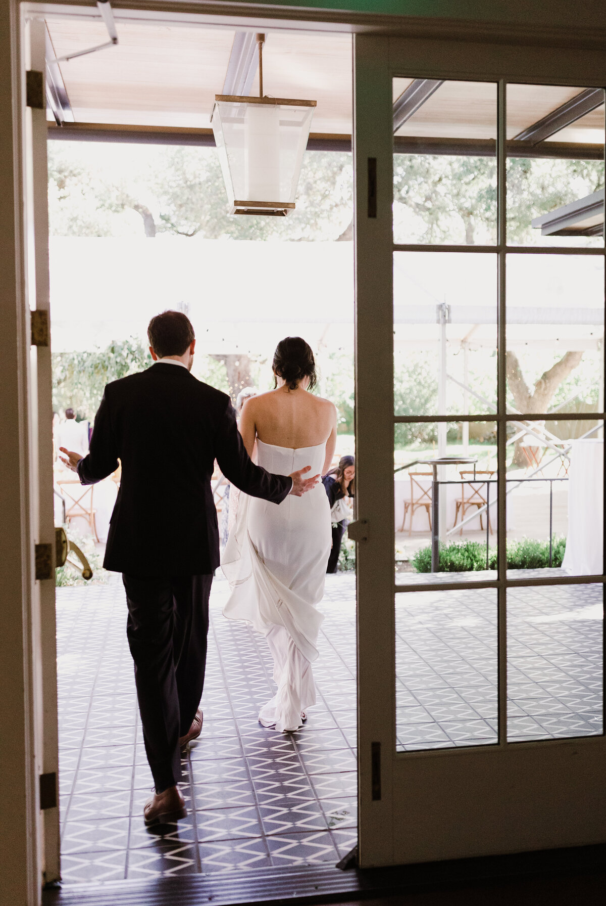 Bride and groom walking through doors at Mattie's wedding venue in Austin
