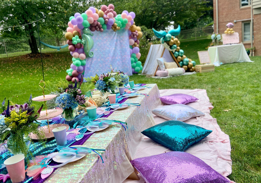 mermaid themed birthday party with metallic picnic decor and pillows