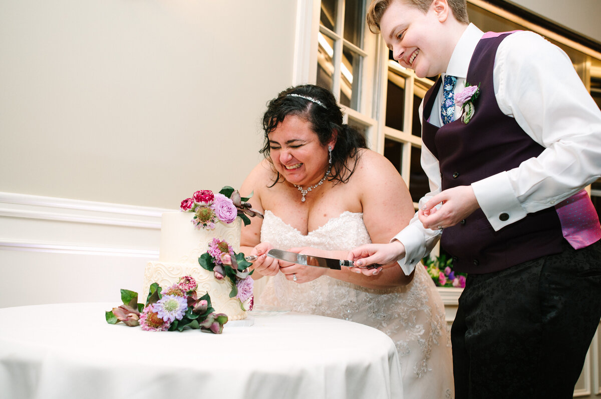 Brides cutting their wedding cake