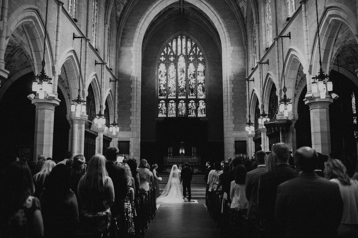 bride and groom at the alter during ceremony in cathedral