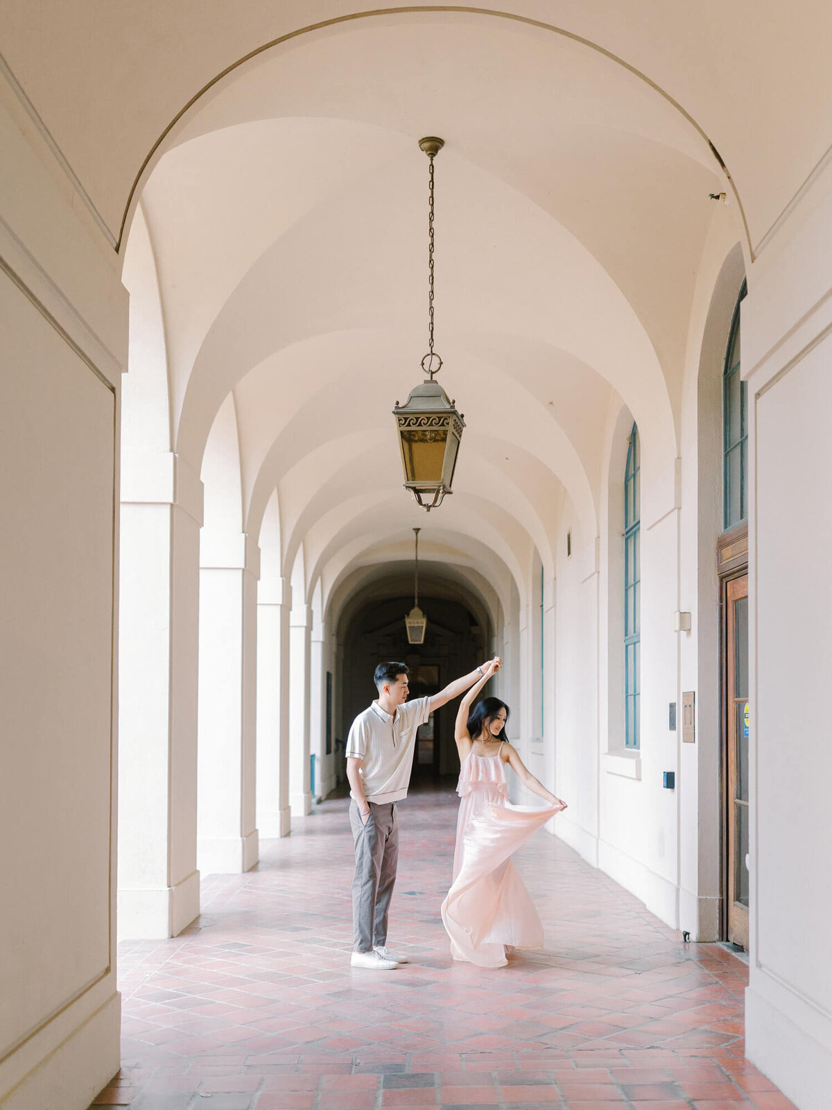 arches at pasadena city hall and engaged couple slow dancing