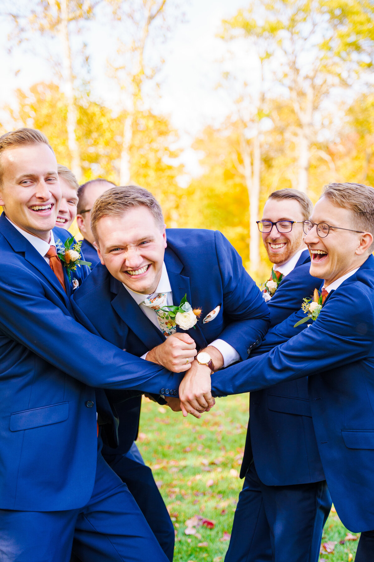 Groomsmen hold up the groom as they all laugh at a wedding at the Pinnacle Golf Course in Grove City, Ohio.