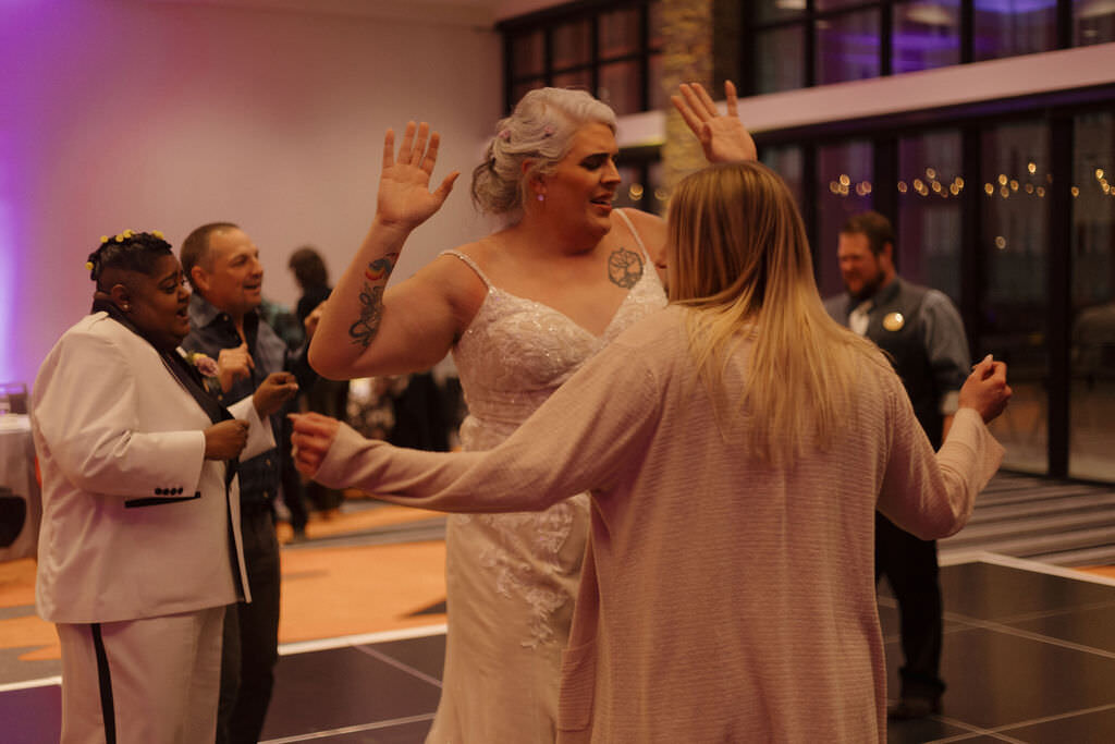 A person dancing with their wedding guests.