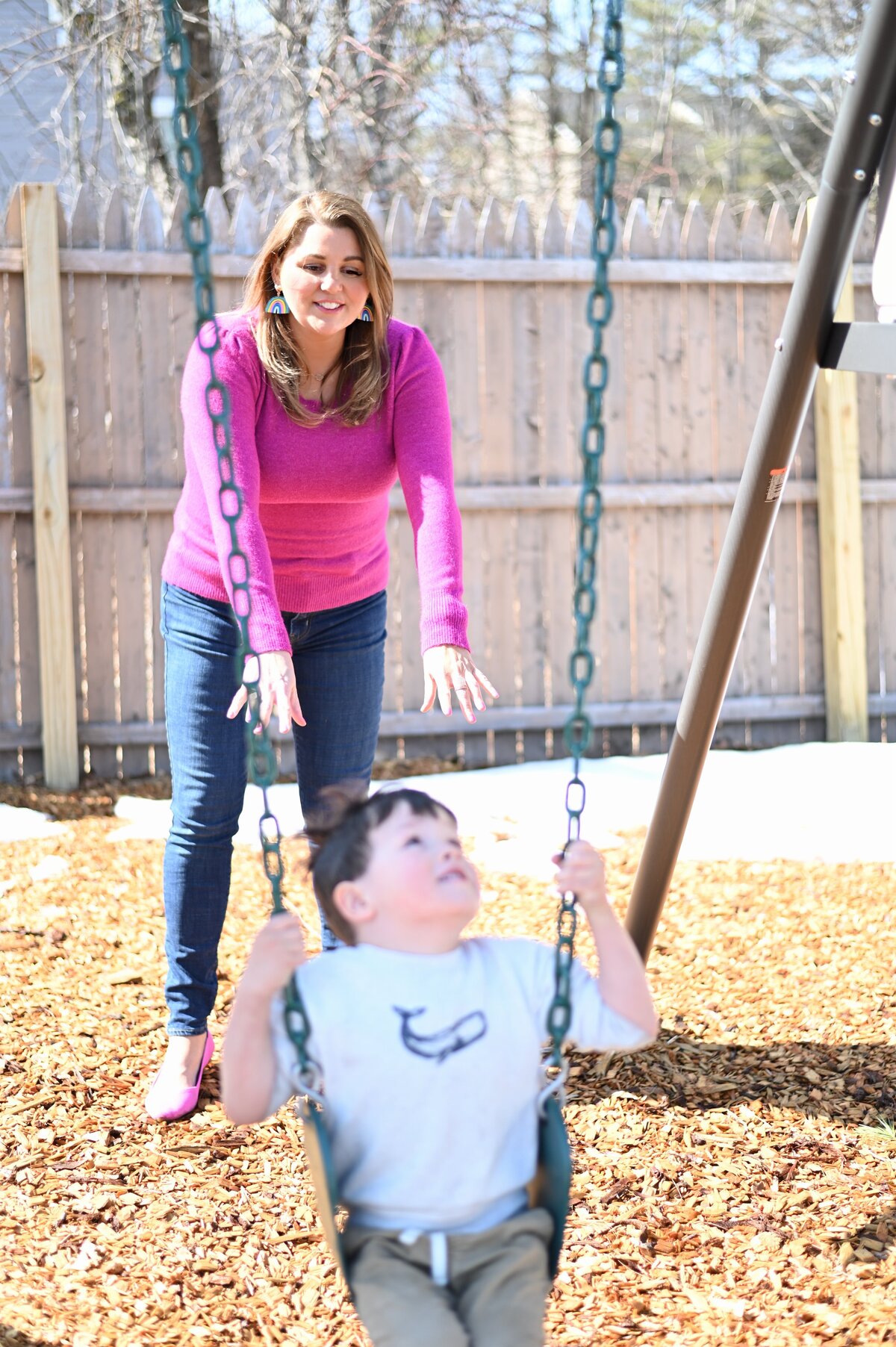 Mrs. Hanscome pushing student on swing at House of Parker Preschool in Gorham, ME