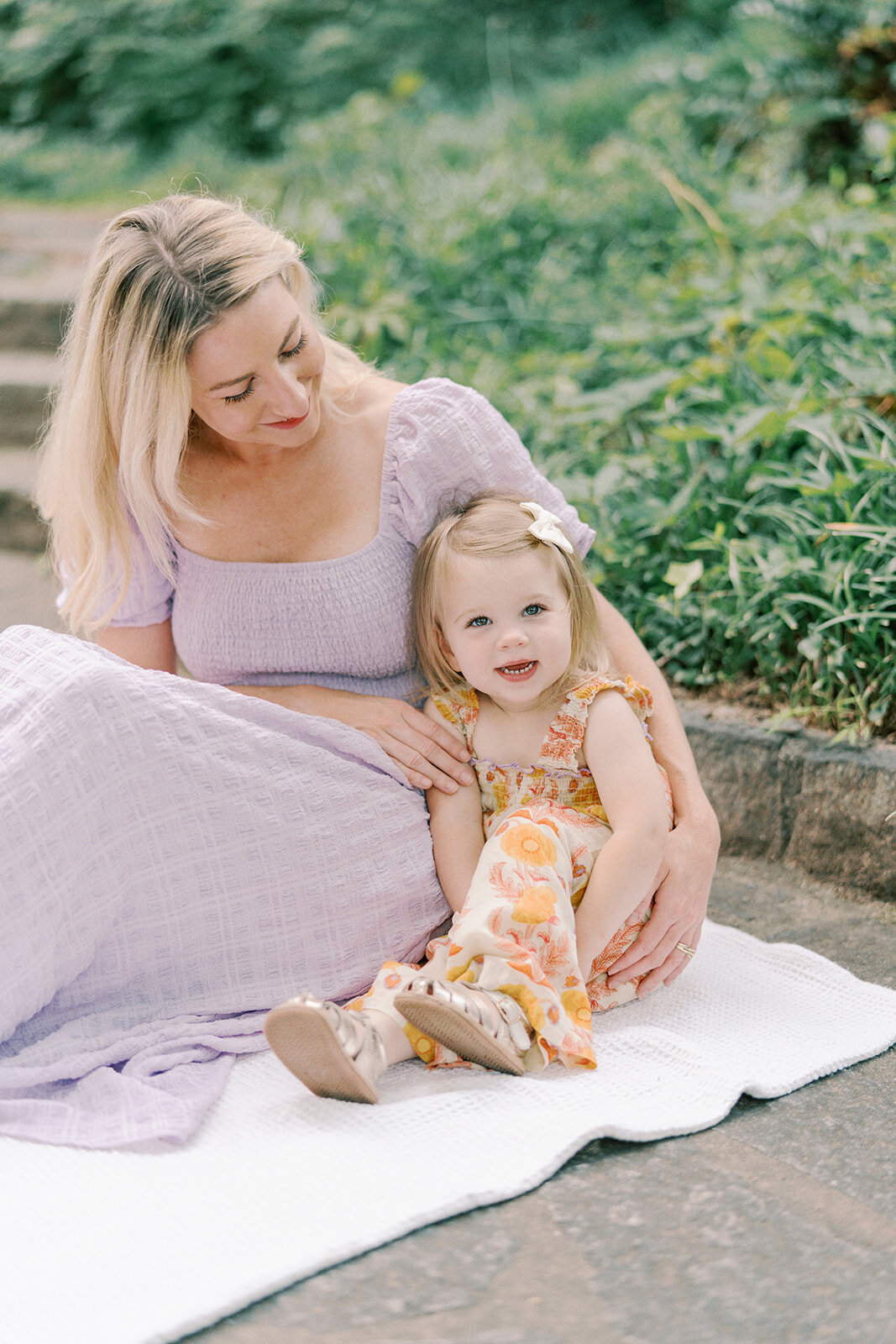 mom and daughter snuggling on a blanket winn park atlanta photography
