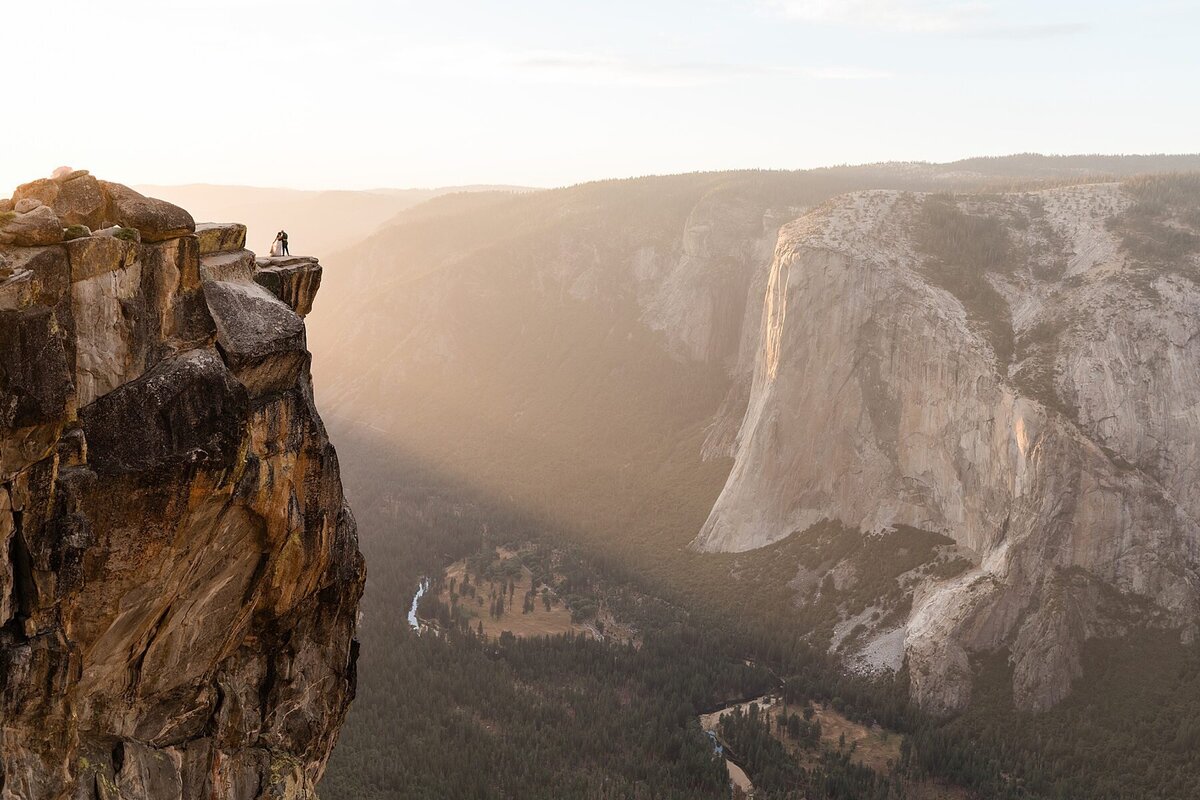 A bride and groom kiss at the top of Taft Point in Yosemite National Park on their elopement wedding day.